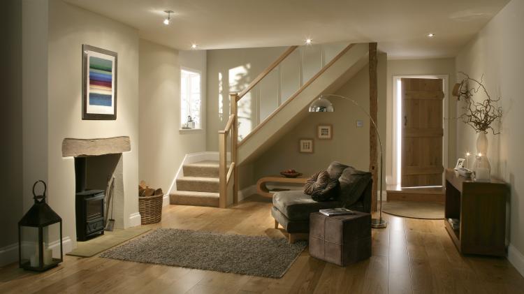 A glass cottage staircase design with oak floor and oak doors.