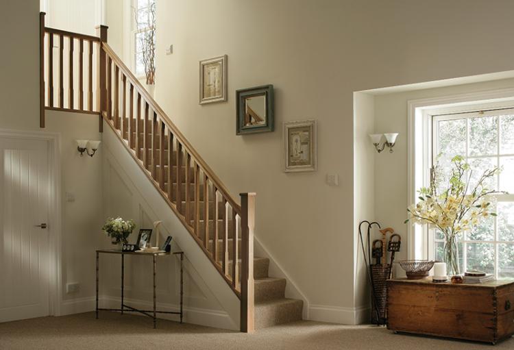 Stop Chamfered Oak timber stairparts in a home with brown carpet and cream walls.