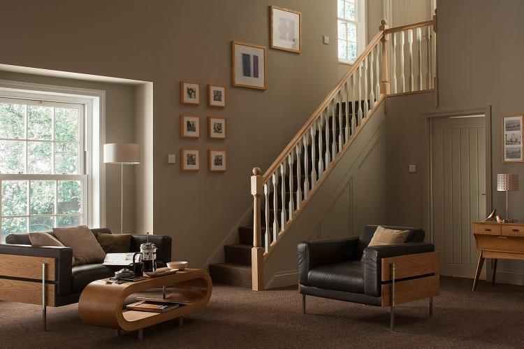 A wood staircase with white painted spindles in a home.