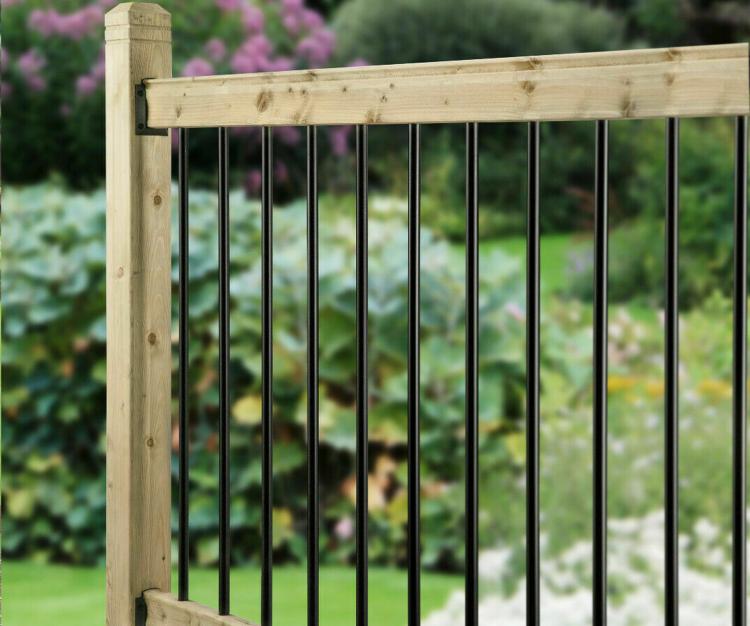 Black iron and timber decking in front of a garden back drop.